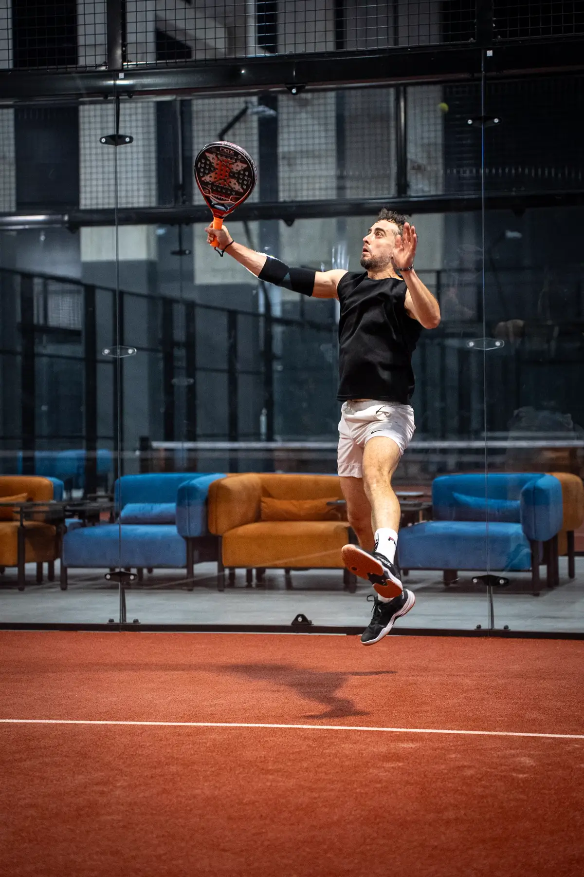 Padel player hitting a jump smash